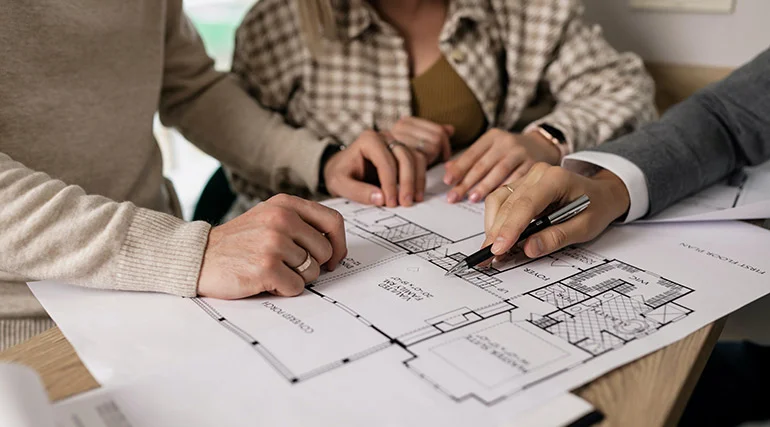 Team reviewing property blueprints